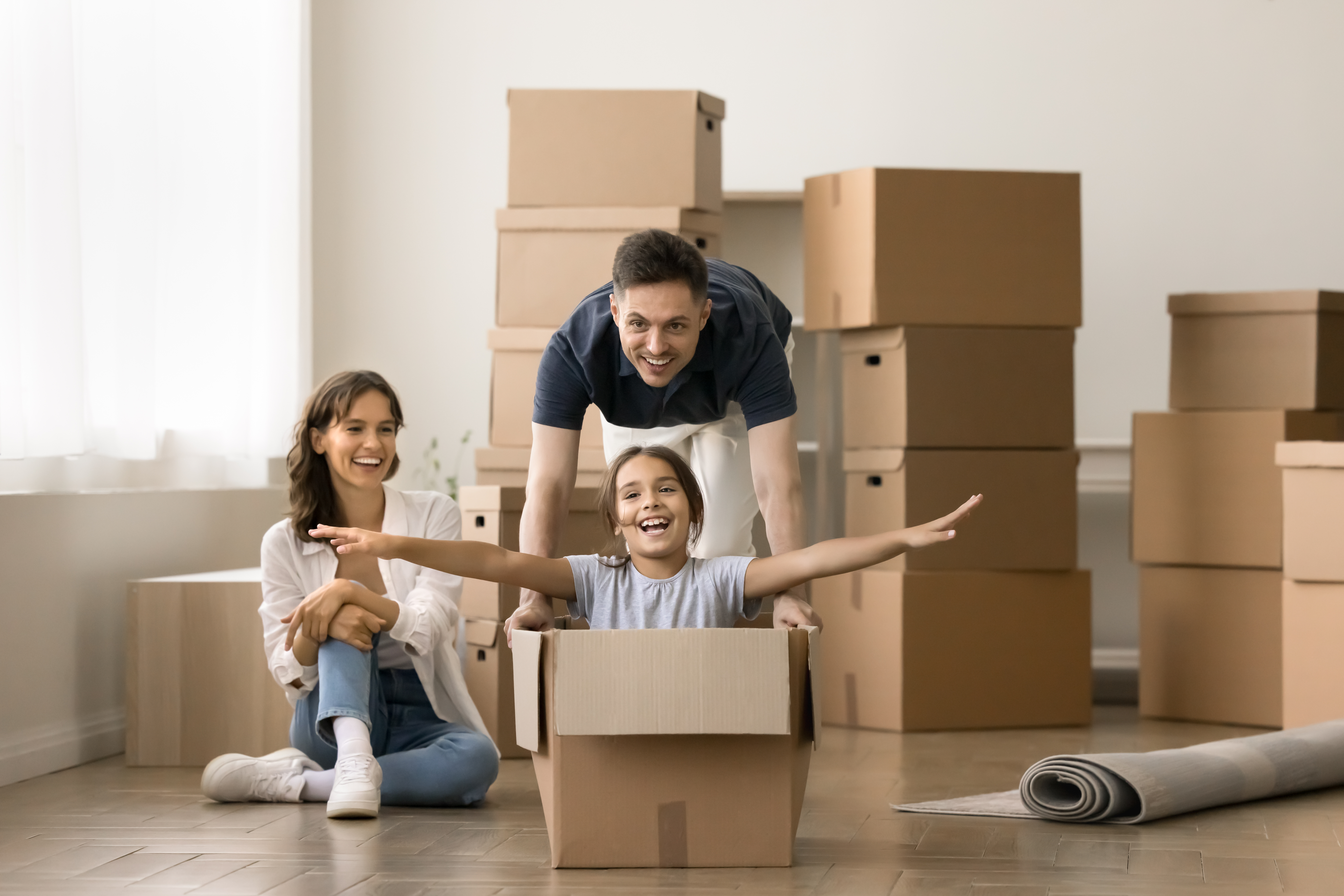 Happy young parents playing active games with kid