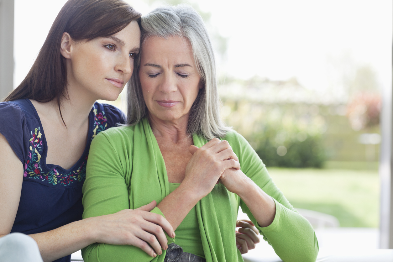Woman consoling sad mother with depression.